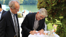 Stephen Salyer and Jochen Fried officially sign the GCA into being at a celebratory ceremony at Schloss Leopoldskron