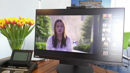 A computer screen showing a snapshot of the first webinar on a desk next to a vase of flowers and a phone. Picture supplied by Patricia Alberth.