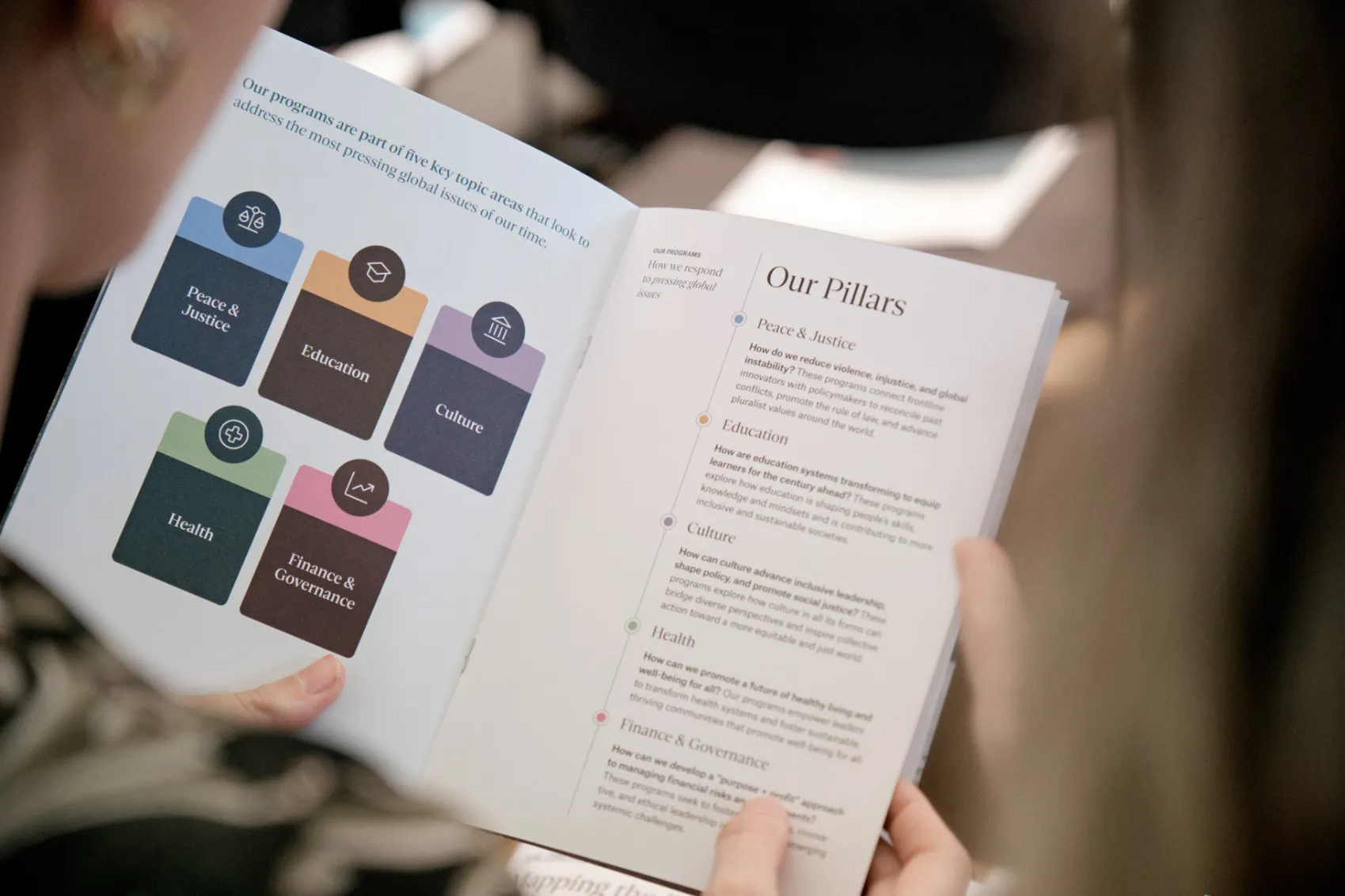 Person reads a brochure about Salzburg Global Programs