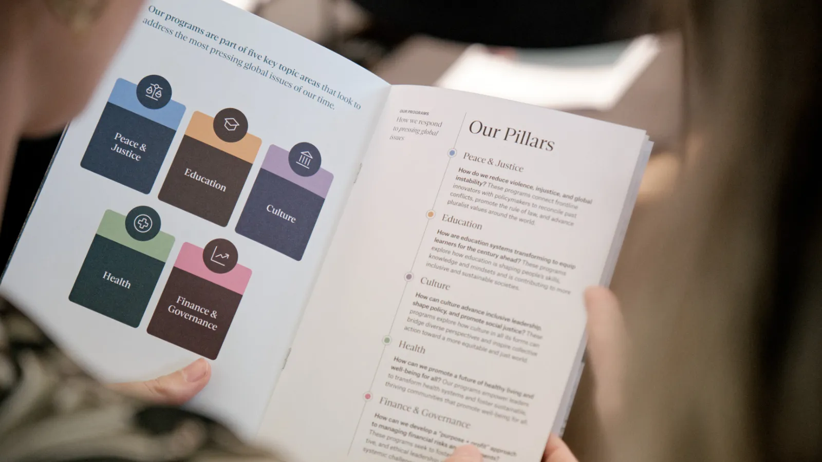 Person reads a brochure about Salzburg Global Programs