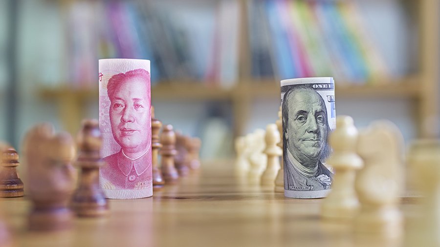 A Chinese Yuan bill and a US dollar bill on a chess board