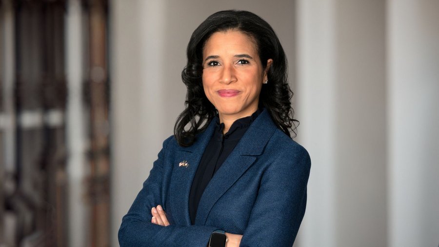 a headshot of a woman juxtaposed over a blurry background