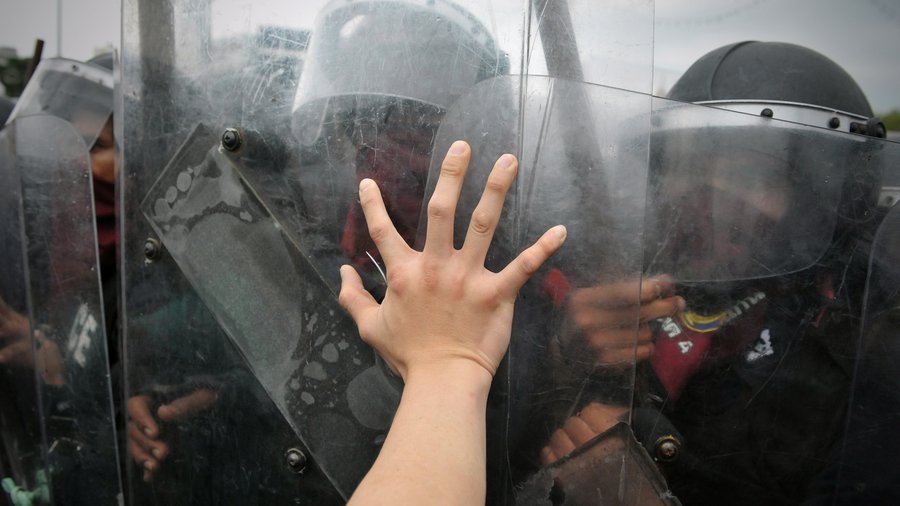 A protester from the nationalist Pitak Siam group pushes the shield of riot police during a violent anti-government rally with riot police on Nov 24, 2012 in Bangkok, Thailand.