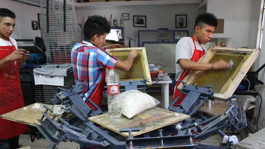 Three young men doing arts and craft