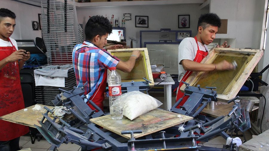 Three young men doing arts and craft
