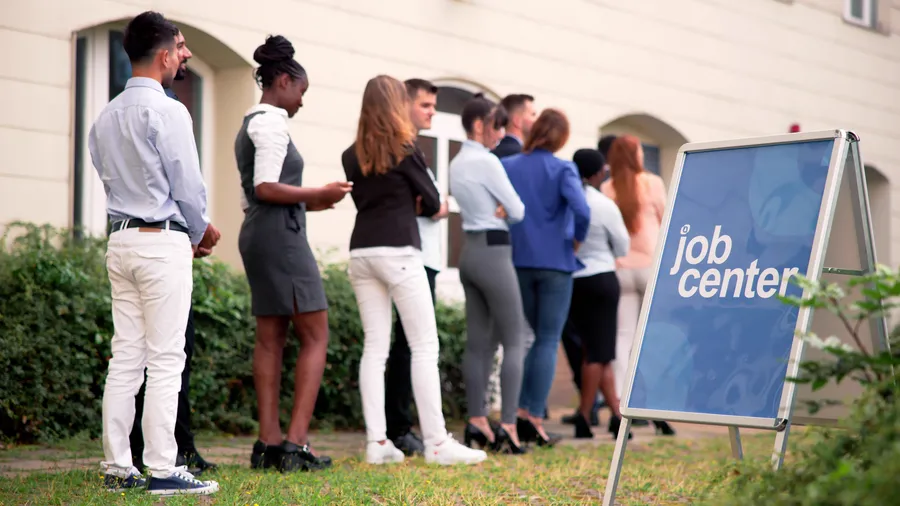 A line of people stands outside a job center