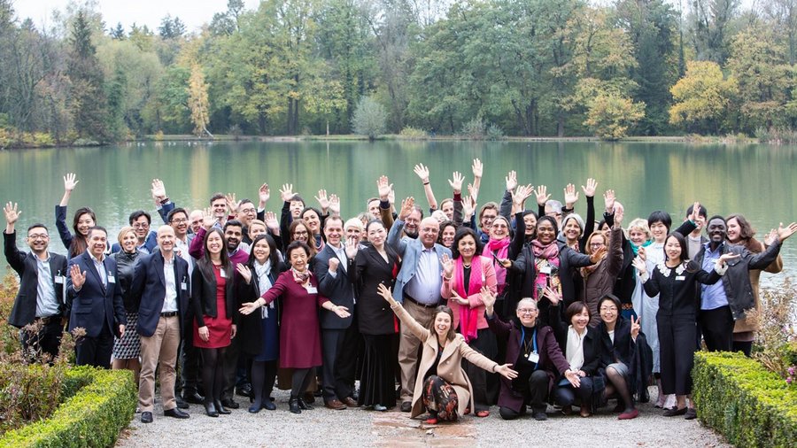 Participants of New Horizons in Social Investment – Global Exchange for Action and Impact pose for a group photo outside Schloss Leopoldskron
