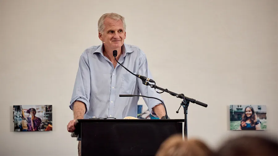 Timothy Snyder speaks at a podium in the Gallery of Schloss Leopoldskron
