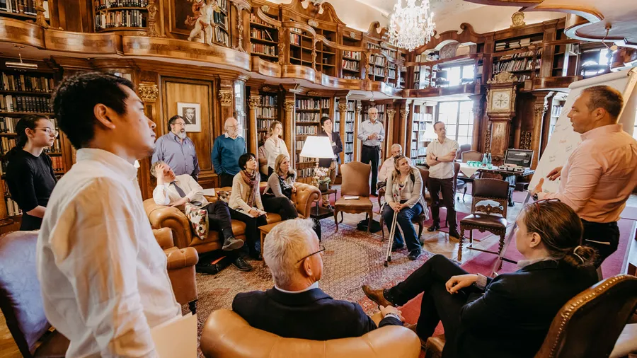 Salzburg Global Fellows in discussion in Schloss Leopoldskron's Max Reinhardt Library