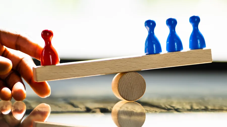 A scale with blue and red figures on top.