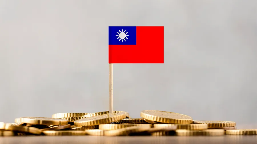 a photo of a small taiwan flag on top of a pile of coins