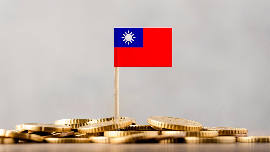 a photo of a small taiwan flag on top of a pile of coins