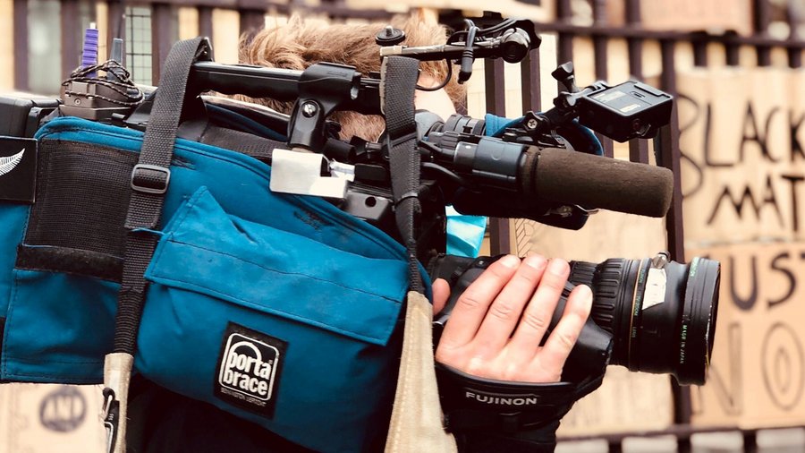 Person with film camera at protest