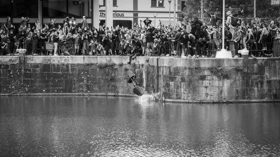 Statue of Edward Colston is thrown into Bristol harbor by Black Lives Matter protesters. Photo credit: Keir Gravil/Flickr https://www.flickr.com/photos/ksagphotos