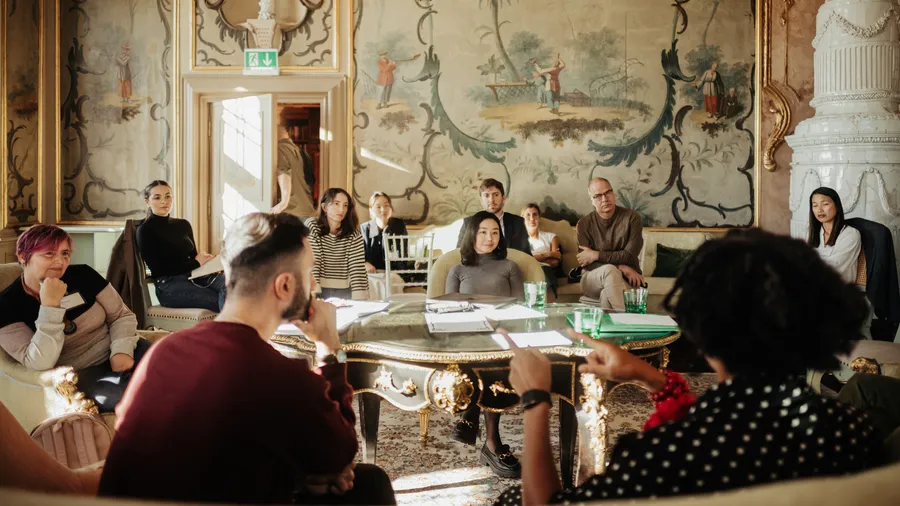 a group of Fellows having a discussion in the Green Salon of Schloss Leopoldskron