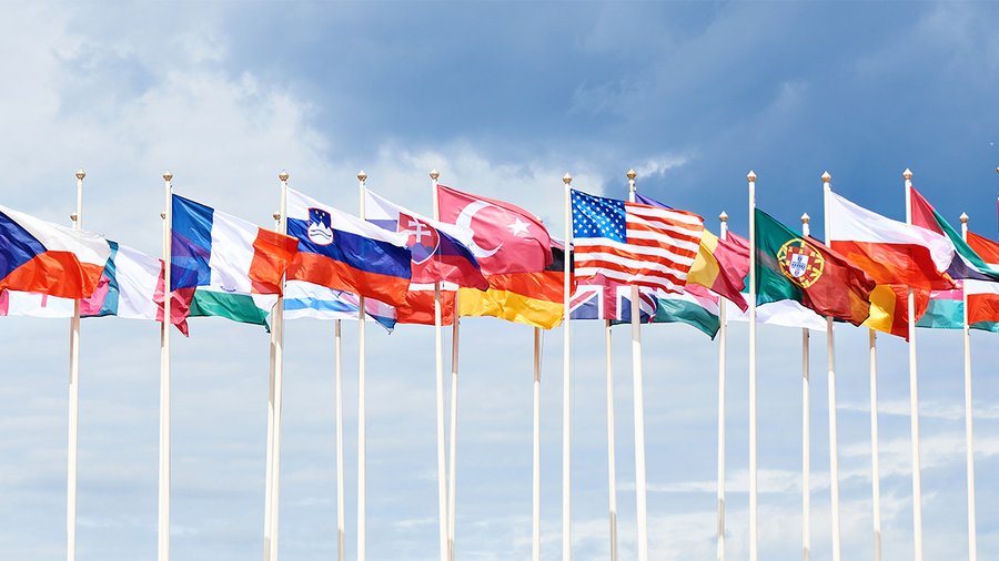 A line of flags from many different countries waving in the wind