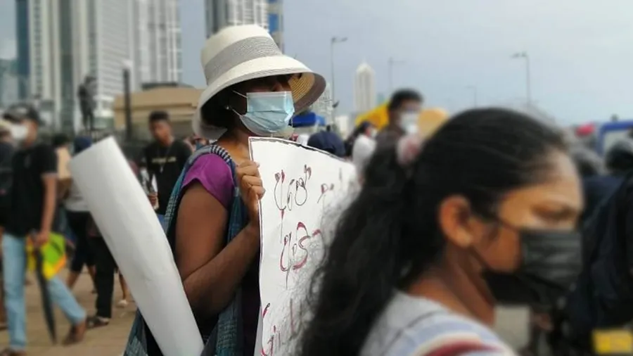 Woman in a protest holding a sign