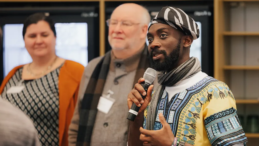A Man Talking into  a Microphon
