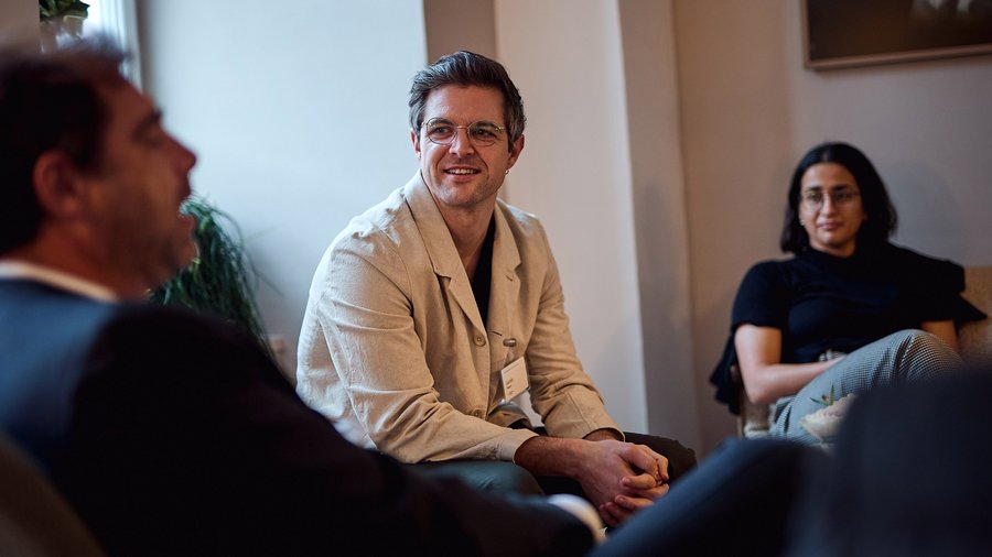 A photo of Jacob Bogart speaking to other Fellows at the International Law Fellows Network in Schloss Leopoldskron.
