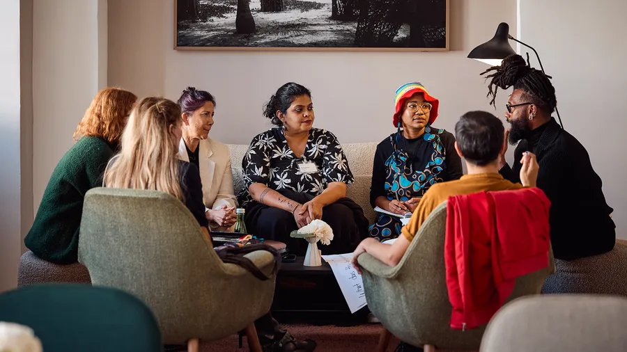 a group of Fellows sit together in the Gonzalez lounge during a discussion