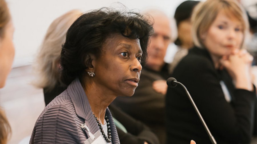 A woman speaks into a microphone