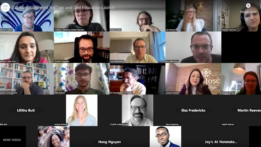 An image of an online video conference screen which shows the faces of many people as individual squares.