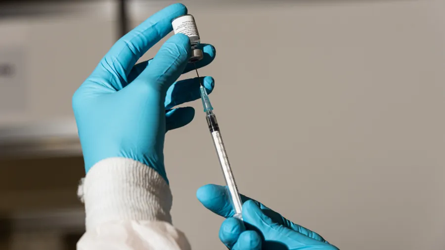 Close-up image of a vaccine and a syringe. 