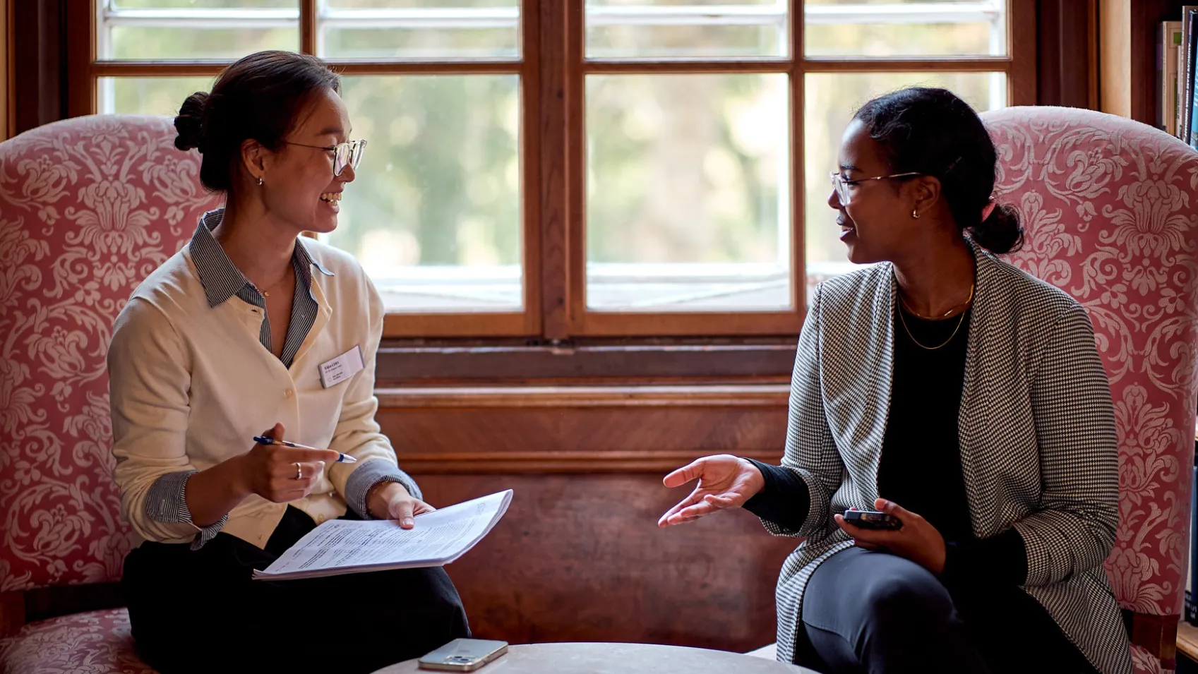 Two females talk beside window inside the Schloss Leopldskron