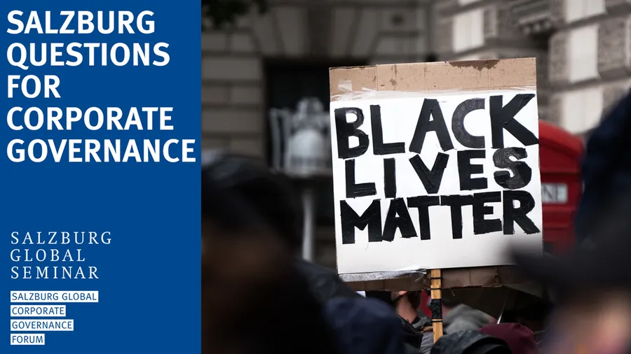 Person with sign that says "Black Lives Matter"