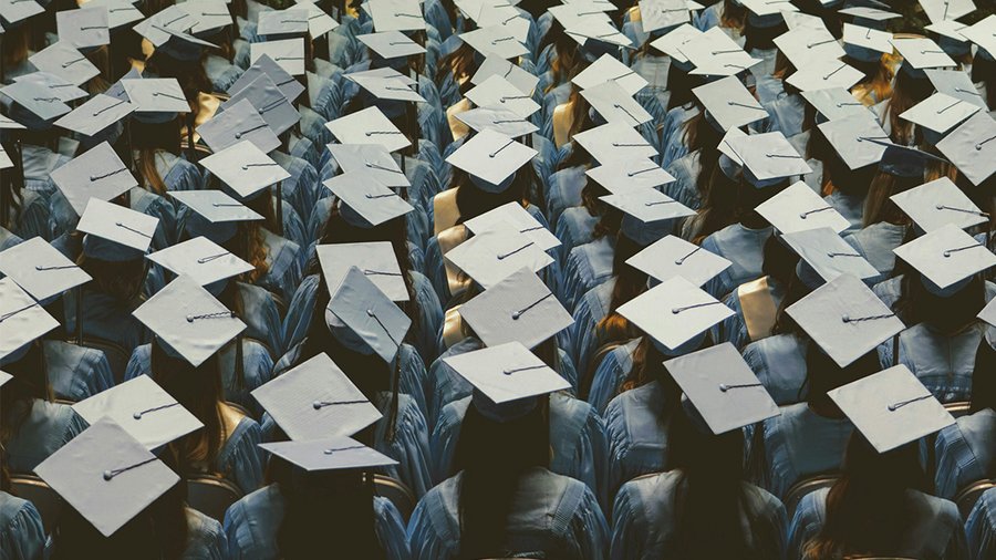 an audience of graduates wearing caps and gowns