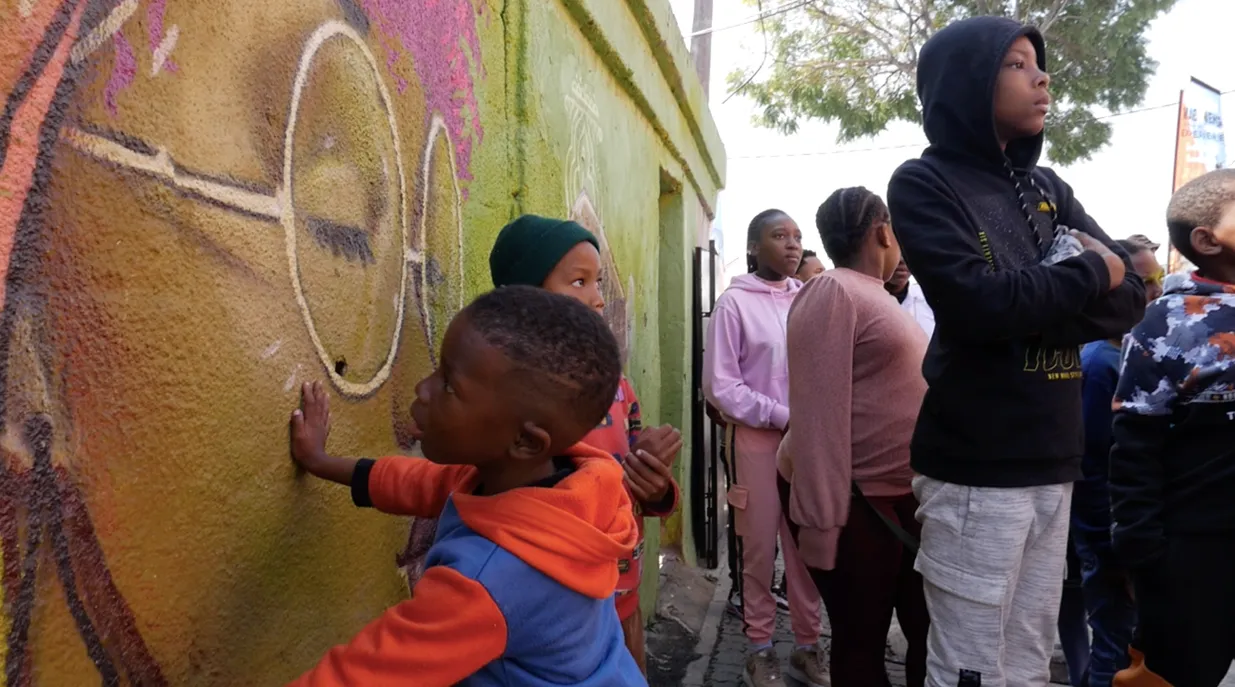 Kids and Grown Ups in front of a Wall