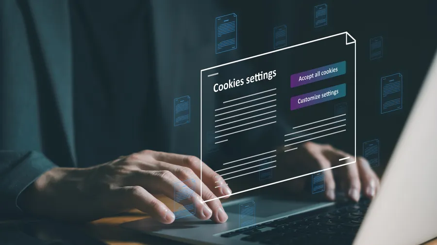 hand using laptop while choosing to accept internet cookies policy or reject