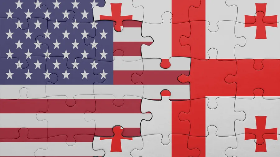 puzzle with the colourful national flag of georgia and flag of united states of america . concept