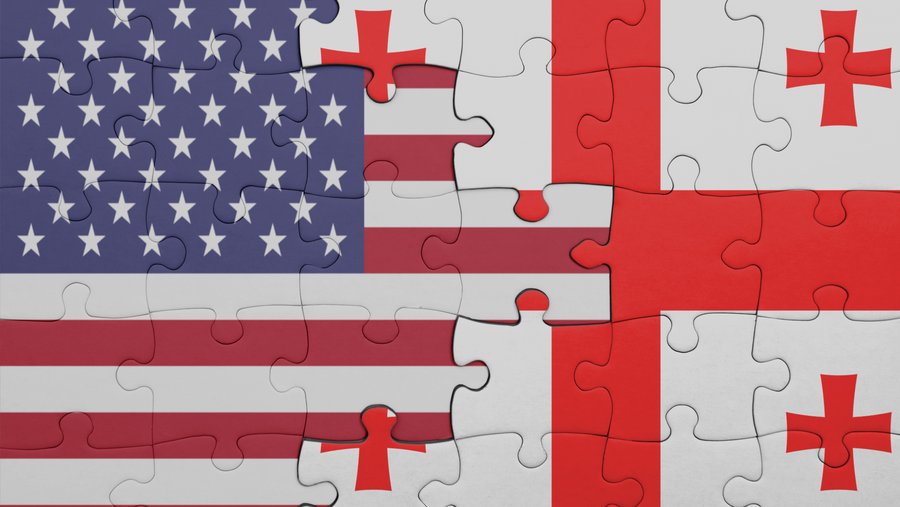 puzzle with the colourful national flag of georgia and flag of united states of america . concept