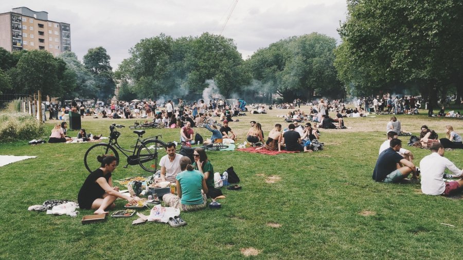 People gathered in a public park in London, UK