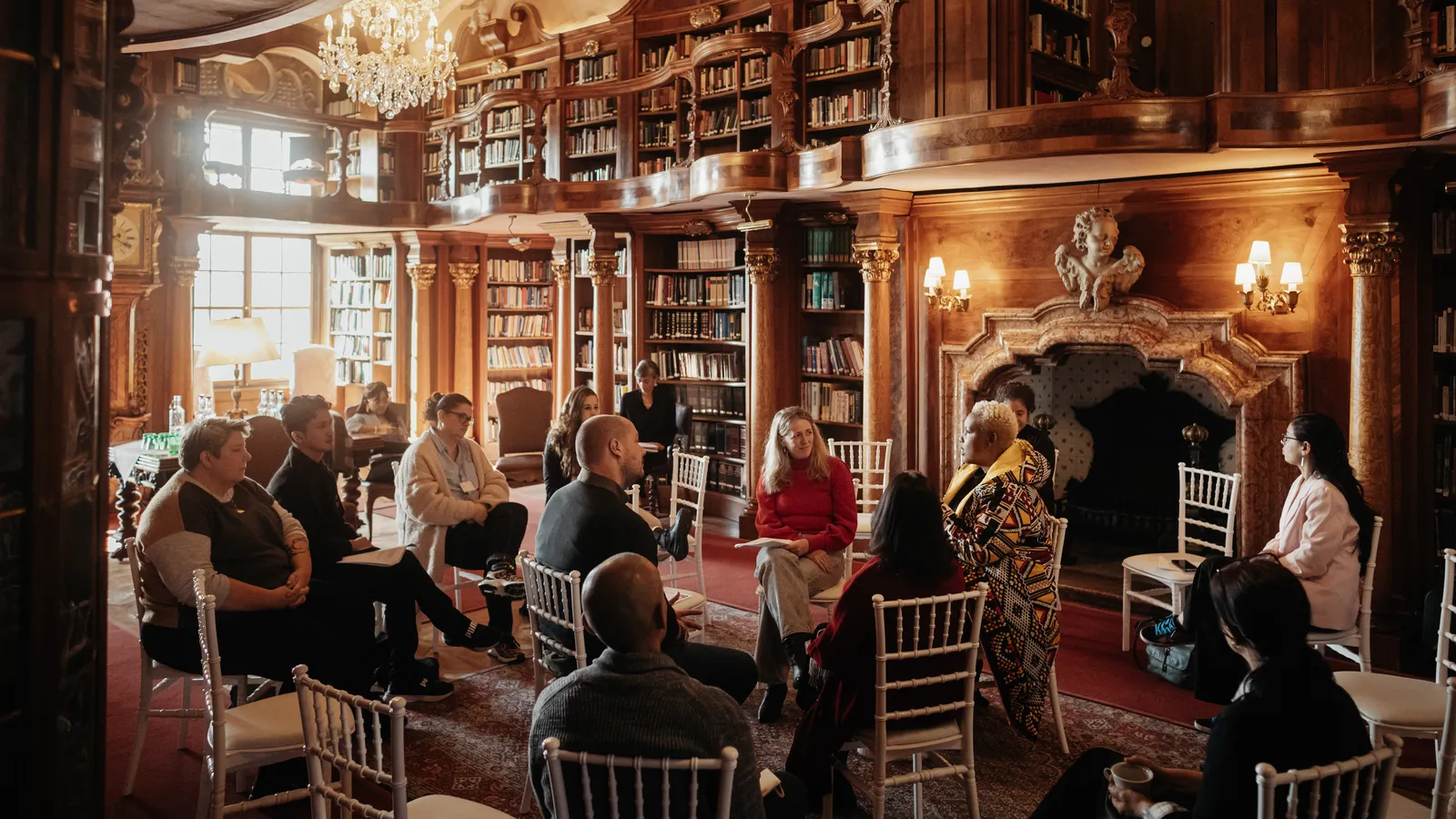 Fellows gathered around for a discussion in the Schloss Leopoldskron library
