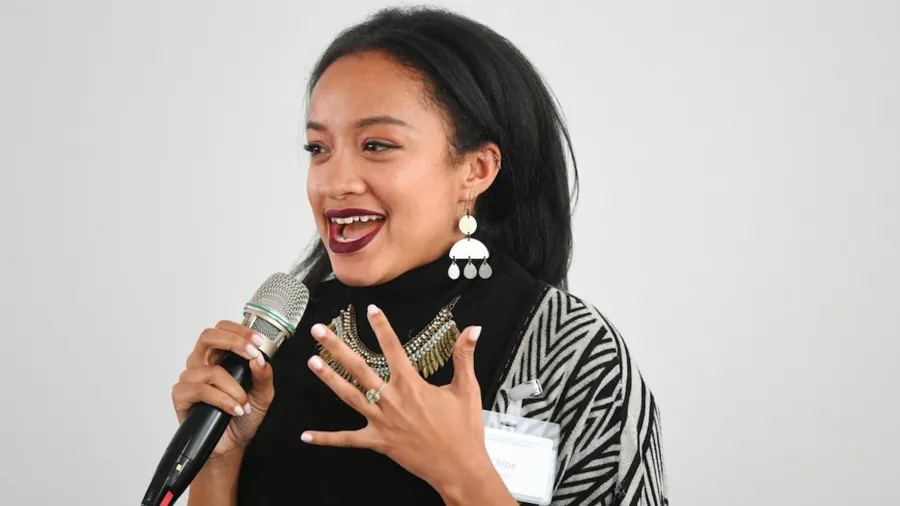 Woman holding a microphone and speaking