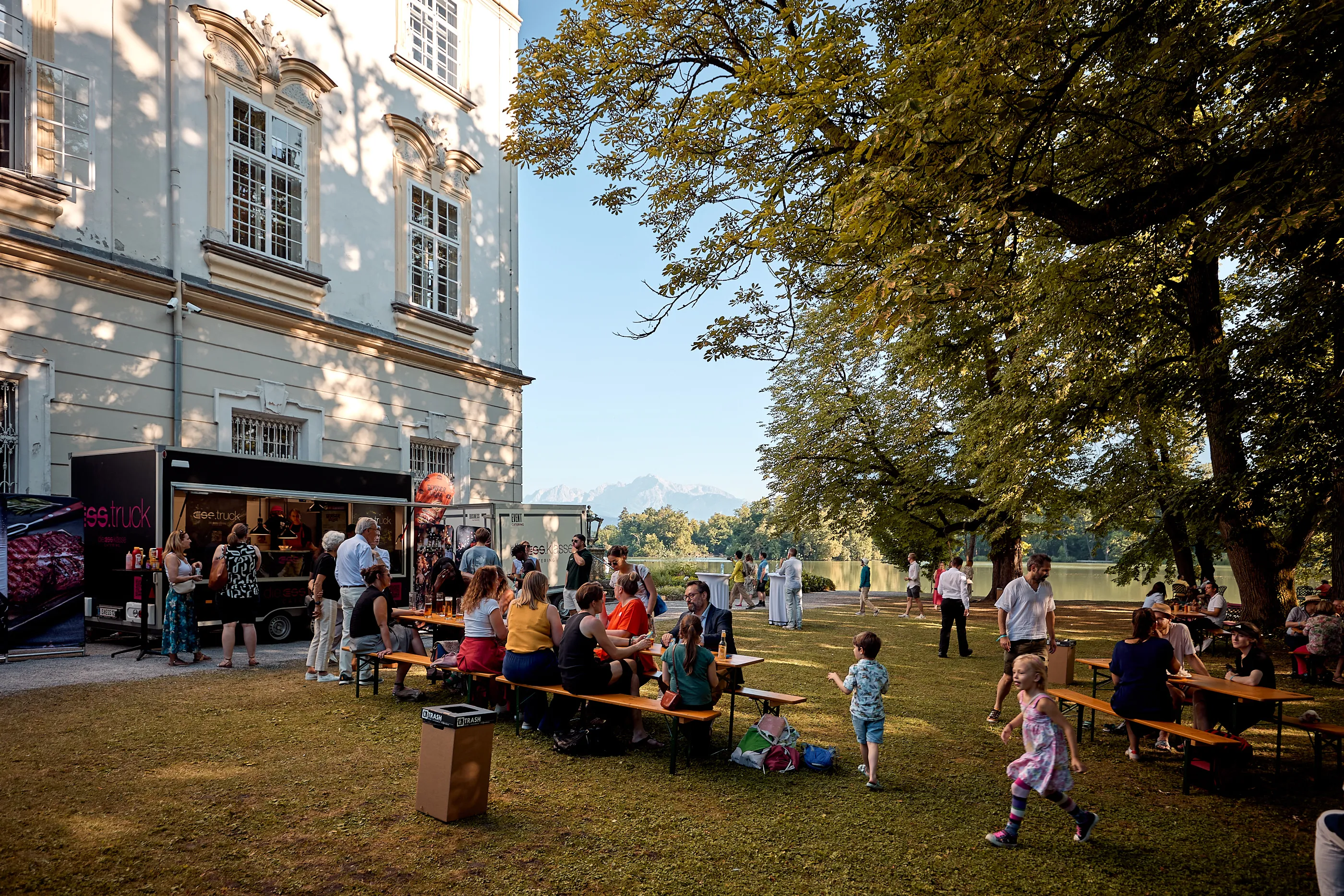 a group of people enjoying the outdoor setting of Schloss Leopoldskron