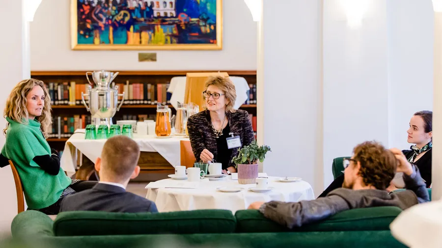 Participants of Session 616 converse over coffee in the main lobby in the Meinhof