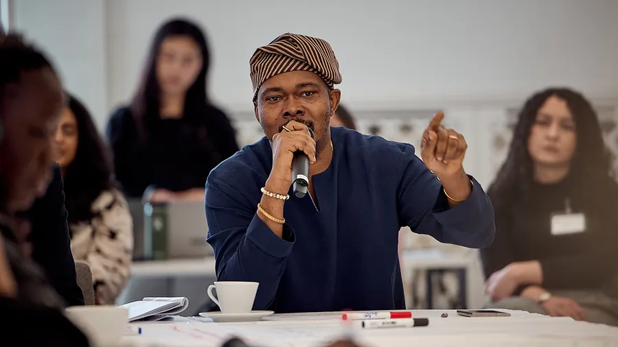 a man holds a microphone while speaking