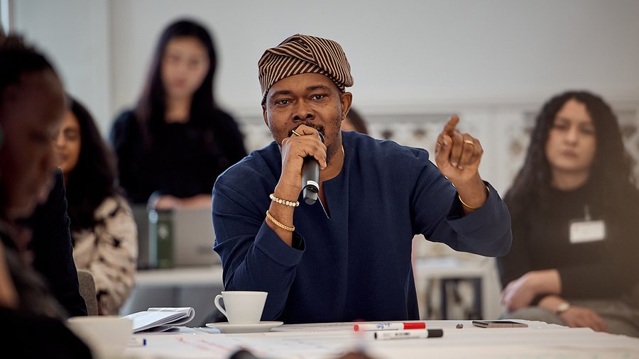 a man holds a microphone while speaking