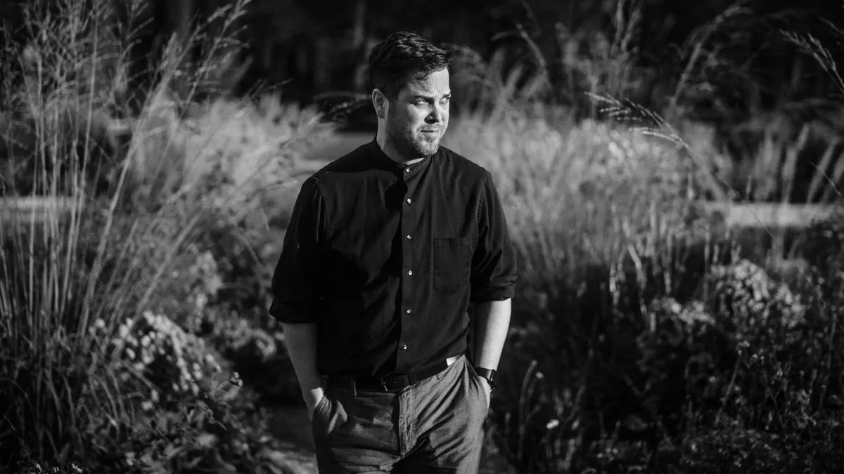 Black and White Photo of a Walking Man