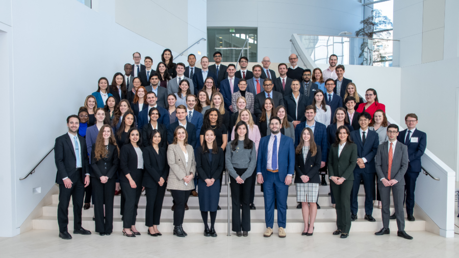 A group photo of young people standing together, they are all well-dressed and look happy.  