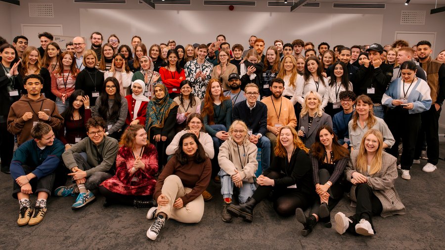a group of young people smiling into the camera
