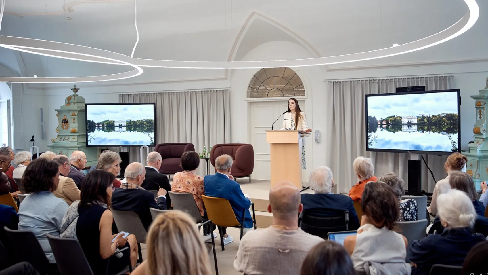 Group of People Holding a Digital Conference With Monitor in the Background
