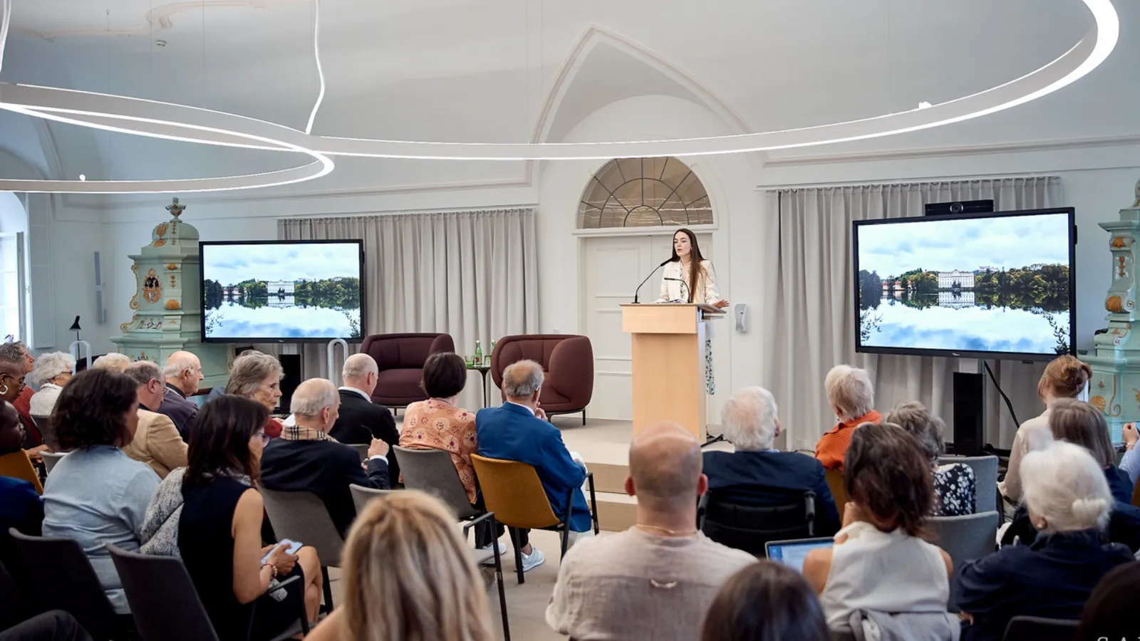 Group of People Holding a Digital Conference With Monitor in the Background