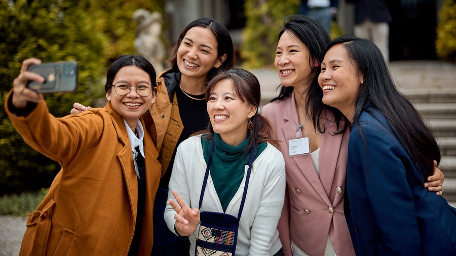 A group of Fellows take a selfie outside of Schloss Leopoldskron at the Asia Peace Innovators Forum