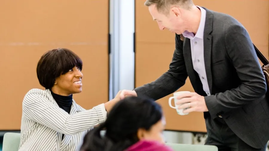 Benjamin Glahn greets a Salzburg Global Fellow