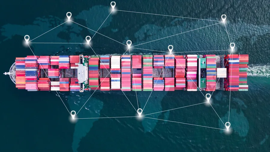 Aerial top view of a large container ship in the open ocean with a map in background.