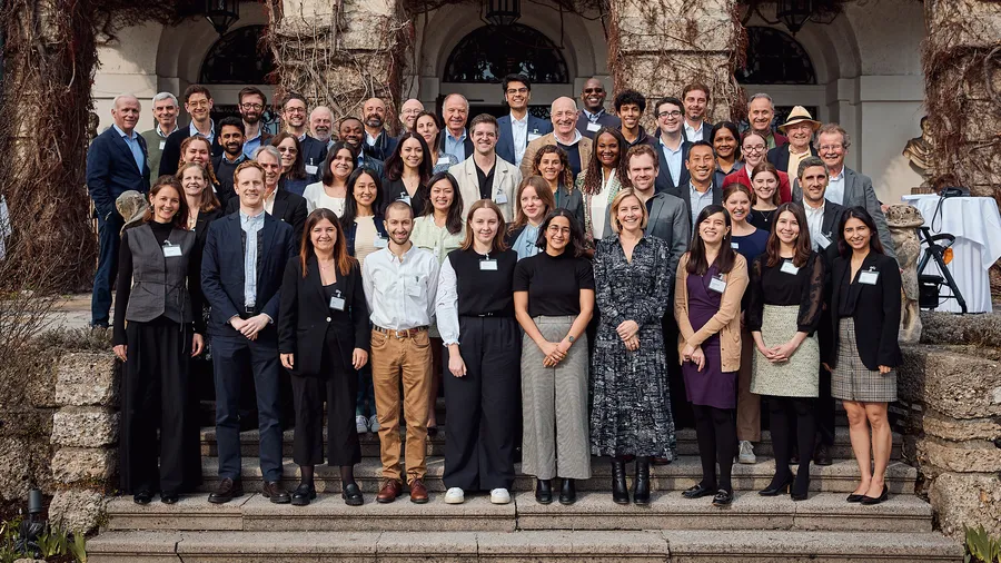 A group of young international law professionals standing in front of Schloss Leopoldskron.